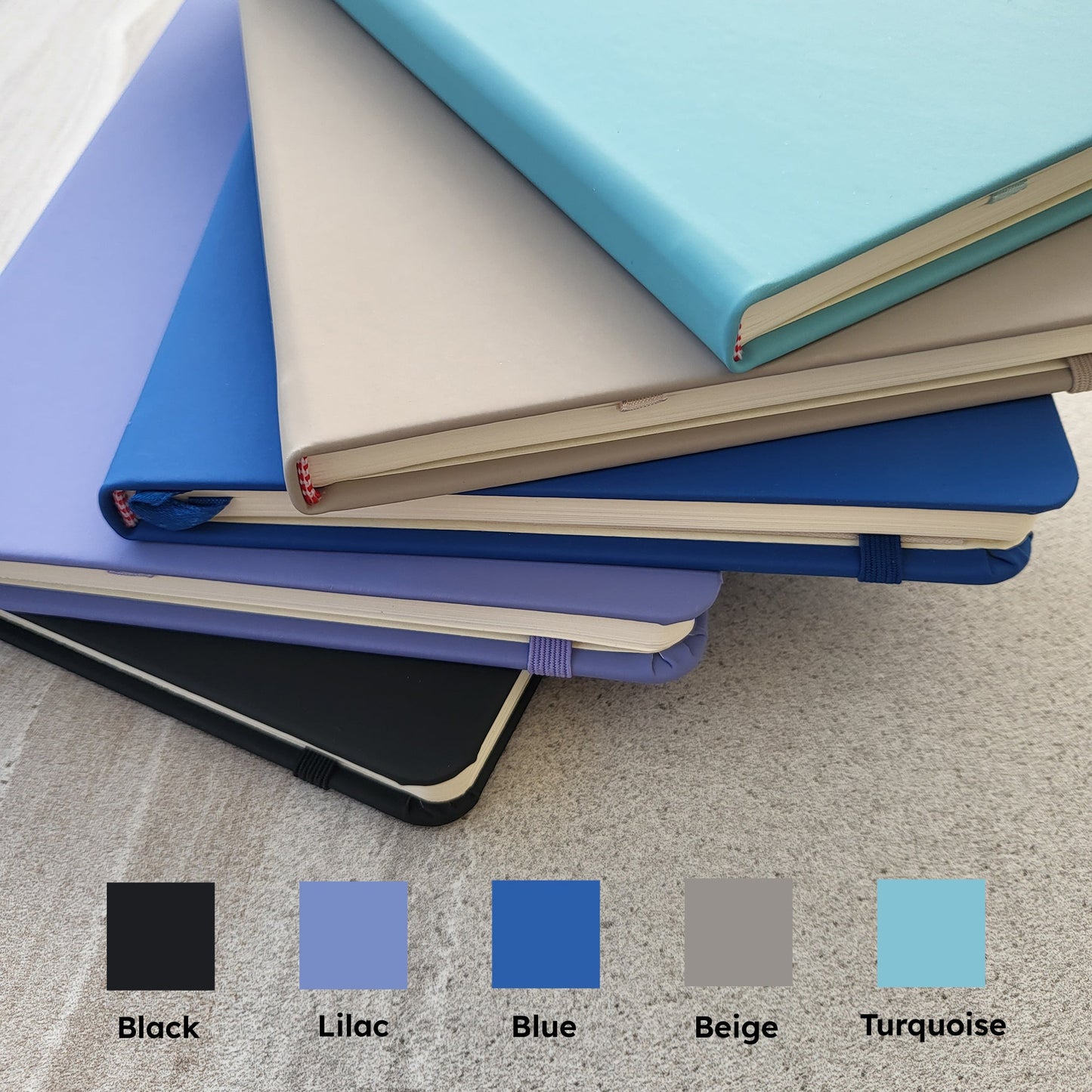 Coloured books together with a colour map - black, lilac, blue, beige, turquoise