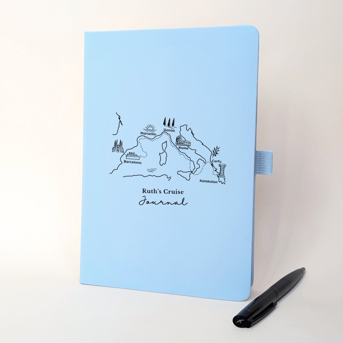 Light blue personalised cruise journal with black Mediterranean route design featuring six ports, landmarks and a matching black pen.