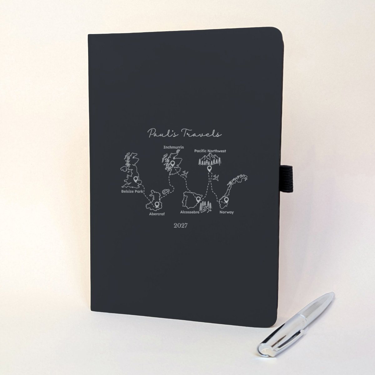 Black personalised travel journal with silver foiled journey design connecting six meaningful destinations, including Scotland, Spain and Norway.