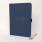 Navy personalised journal with gold pen and the wording “The one where Dom turns 50”, a personalised milestone birthday journal and keepsake gift for celebrating a special birthday.