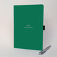 Green personalised employee appreciation journal for Tom reading “Quietly Brilliant”, shown with a silver pen.
