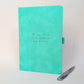 Turquoise personalised journal with matching silver pen featuring “The one where Sophie follows her dreams”, showing how the journal can be customised for a new beginning, achievement or exciting life change.