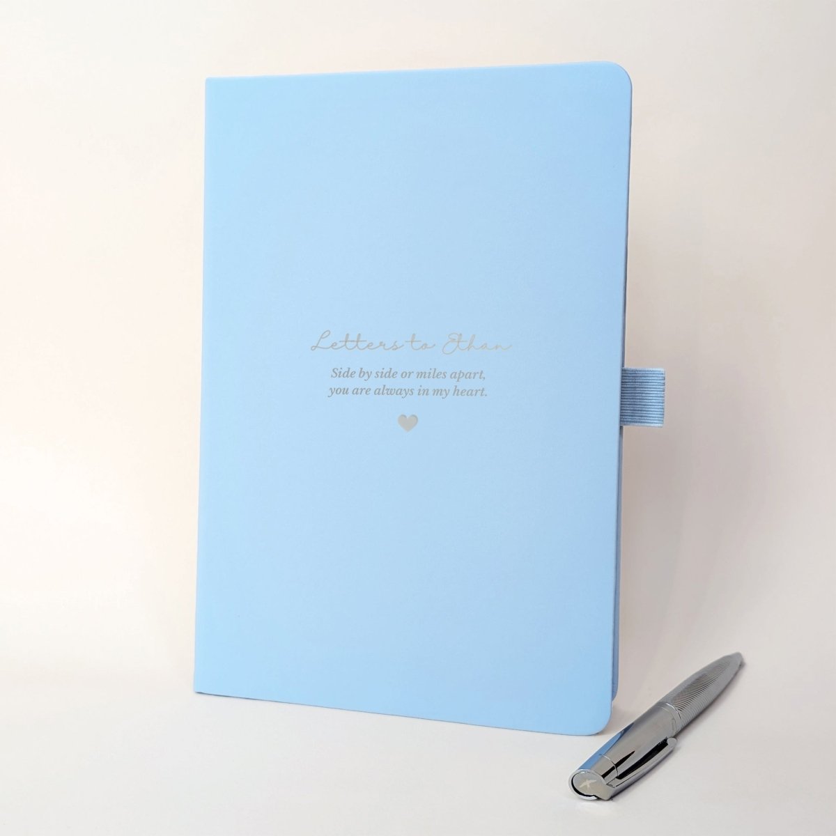 Personalised light blue grief journal for a son, with “Letters to Ethan”, heartfelt remembrance wording and a silver metal pen.
