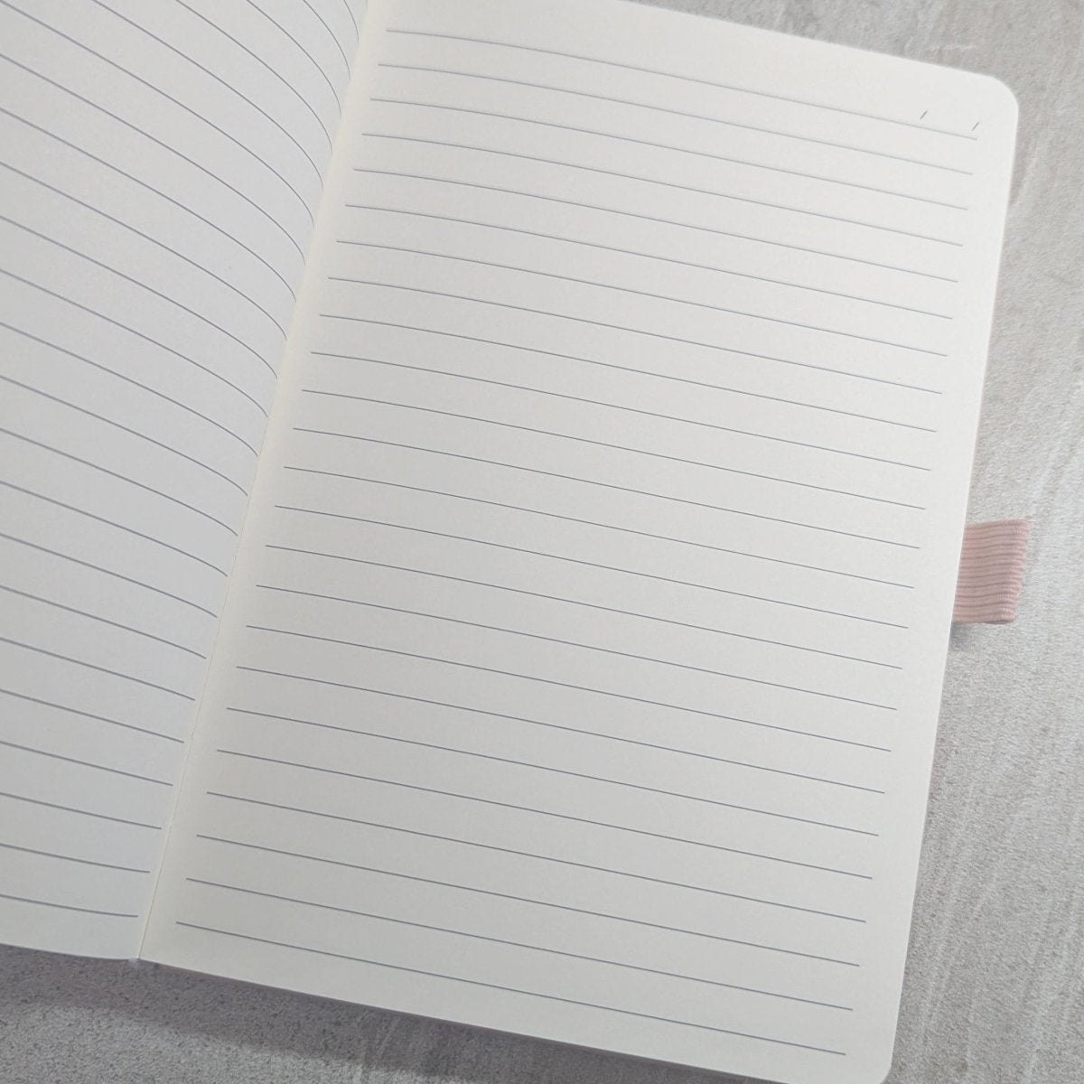 Open A5 keepsake journal showing the thick 100gsm lined writing pages
