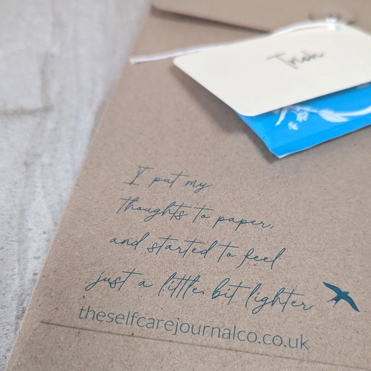Gift packaging for a personalised keepsake journal, showing recyclable kraft presentation packaging, branded details and a gift tag ready for gifting.