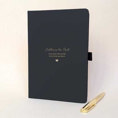 Personalised black memorial journal for Dad with gold “Letters to Dad”, “Gone from this world, never from my heart” wording, heart detail and matching gold metal pen.