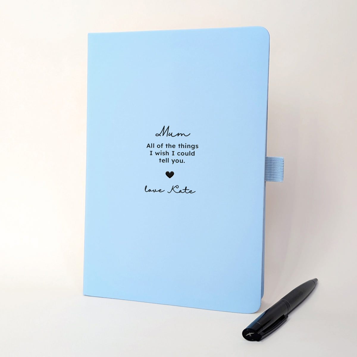 Personalised pale blue Mum memorial journal with black pen featuring All of the things I wish I could tell you. to the front cover