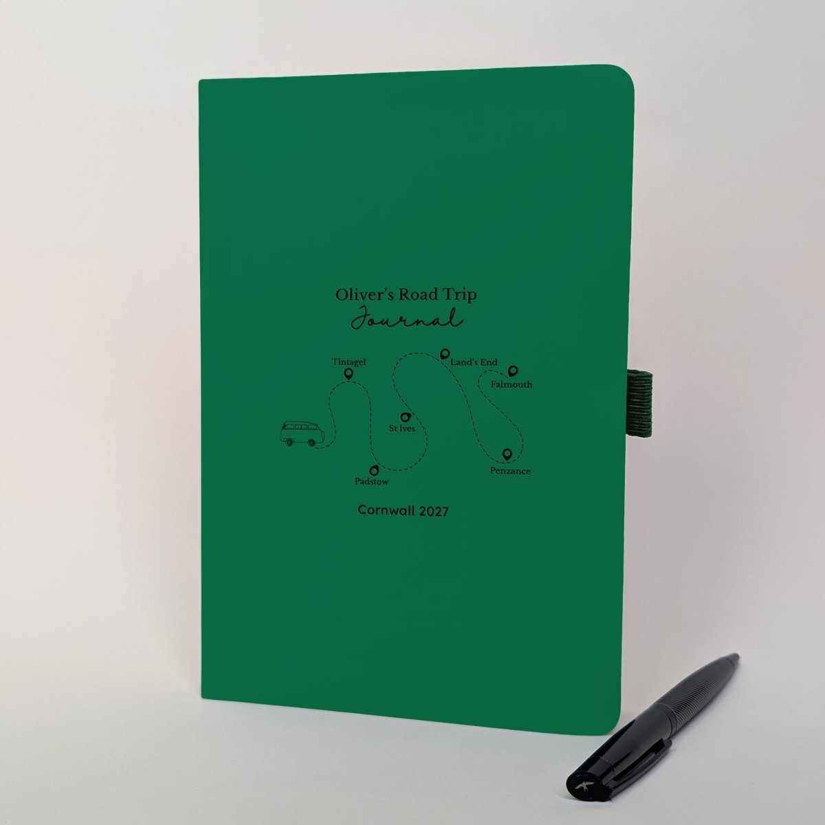 Personalised green road trip journal with campervan, custom Cornwall route and six destination stops, paired with a black metal pen.