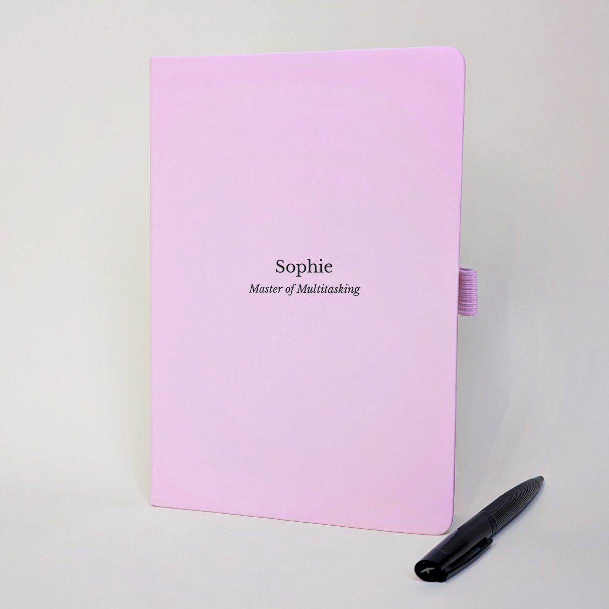 Pink personalised staff appreciation journal for Sophie reading “Master of Multitasking”, shown with a black pen.